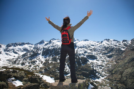 woman at the top of gredos mountains in avila spainの写真素材
