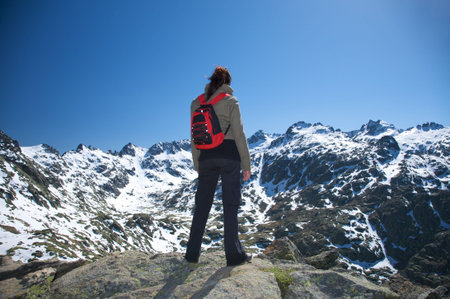 woman at the top of gredos mountains in avila spainの写真素材