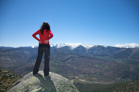 woman at the top of gredos mountains in avila spainの写真素材