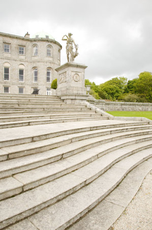 big stone stairs with sculptures and gardenの写真素材