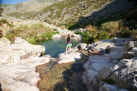 woman on a river at Gredos mountains in Avila Spainの写真素材