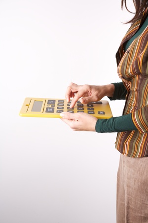 woman detail with a yellow big calculator in her handsの写真素材
