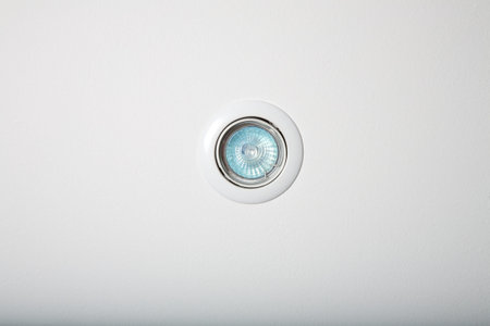 circular floodlight with blue halogen in white roofの写真素材