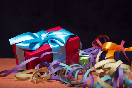 group of gift boxes with black background on party tableの写真素材