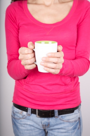 woman portrait holding a tea cup in her handsの写真素材