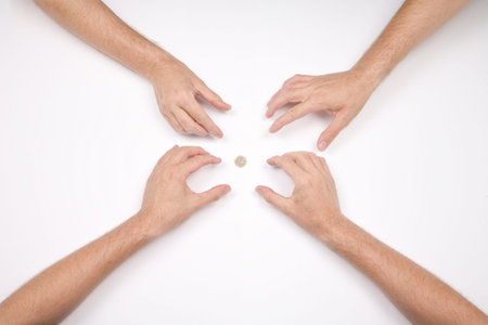 hand of four men and a coin of 1 euro on white backgroundの写真素材