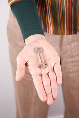 woman detail holding a key in her handの写真素材