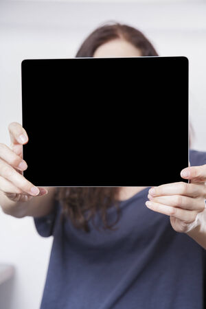 blank black screen tablet close on blue shirt woman handsの写真素材