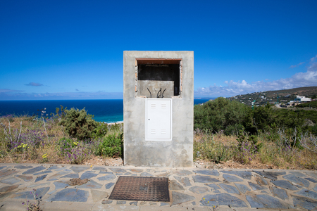 exterior concrete box electric access, in street of urbanization without build, with cables and hole for the control panelの写真素材