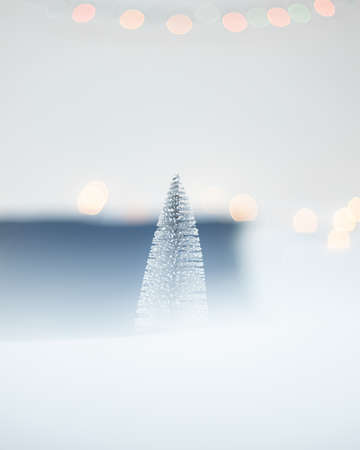 Christmas tree in the snow. Winter background with bokeh.の写真素材