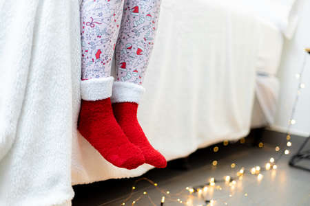 Warm cozy socks on a bed in the bedroom. Christmas decorationの写真素材
