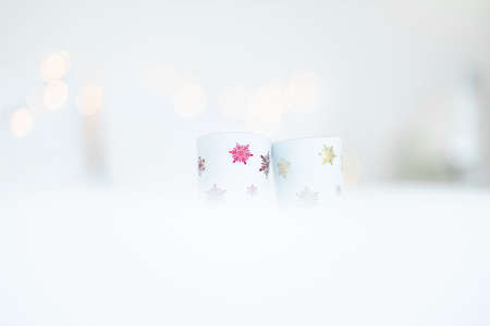 Two cups with snowflakes on a white background. Christmas and New Year concept.の写真素材