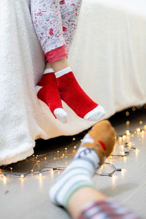 Close-up of child's feet in Christmas socks on the floorの写真素材