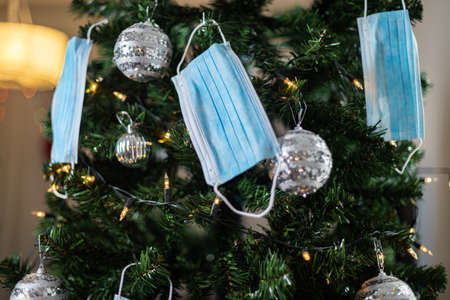 Christmas tree decorated with medical masks during the coronavirus pandemicの写真素材