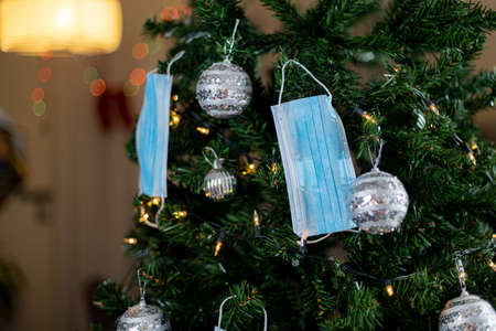 Christmas tree decorated with medical masks. New Year and Christmas concept.の写真素材
