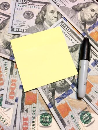 Dollar bills cash with post it note and black marker verticalの写真素材