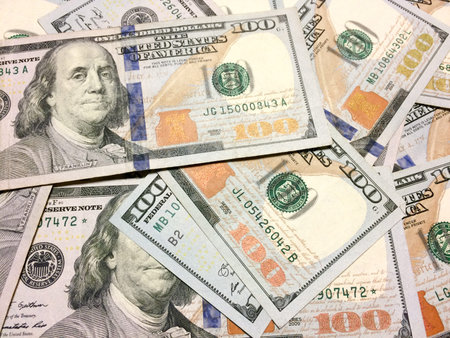 American cash money hundred dollar bills thrown on table aerial view