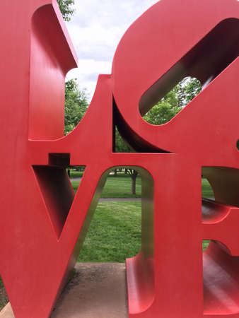 Love art text in big red metal letters in park with grassのeditorial素材