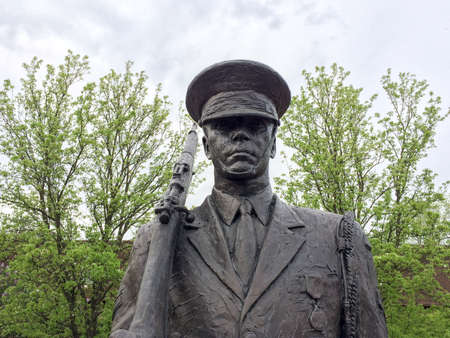 soldier statue stands guard with sky and trees backgoundのeditorial素材