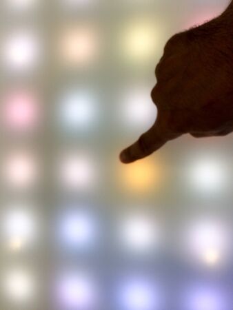 Hand on digital art dot touch screen pattern background dotsの写真素材