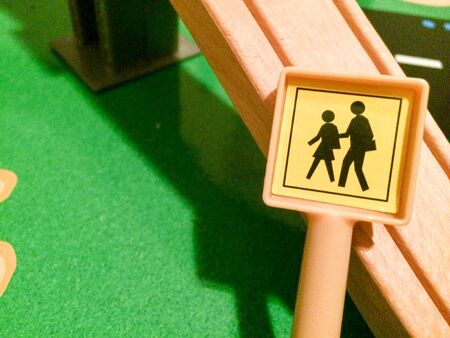 People walking crossing street sign in toy city play town in miniature sizeの写真素材
