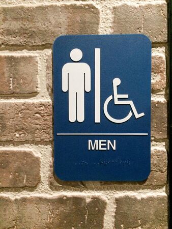 Men restroom blue white sign handicapped pictogram symbol on brick wallの写真素材