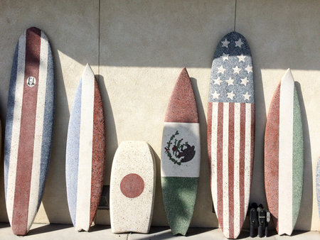 Surfboards with American and Mexico Japan flag at beach sunny day sport background