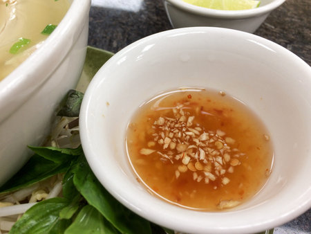 Garlic ginger chili fish sauce in white bowl for vietnamese pho soup