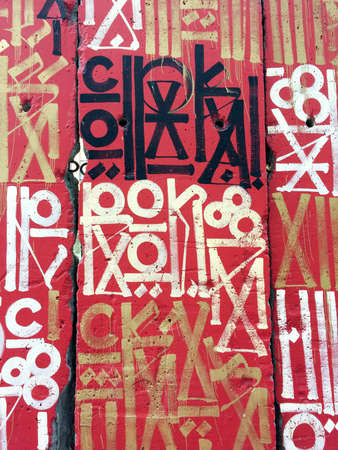 Urban street art graffiti background red gold black white symbolsのeditorial素材