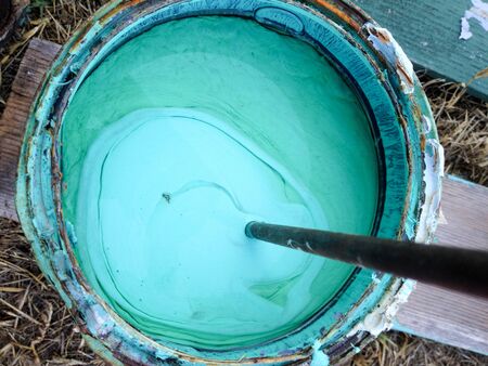 Aqua blue green turquoise paint mixed in bucket home repair improvementの写真素材