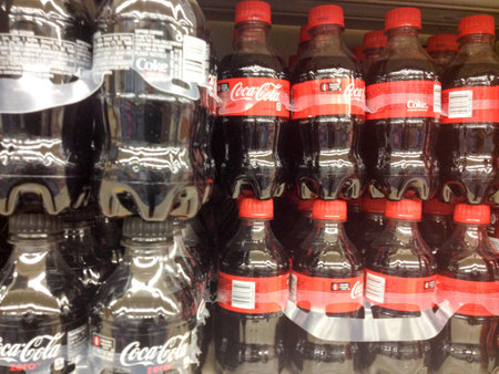 Plastic bottles Coke zero classic coca cola cases stacked in supermarket background pattern