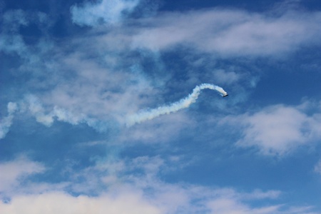 Closeup on airplane contrail against clear blue sky の写真素材