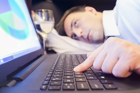 Tired businessman on the office desk during work.の写真素材