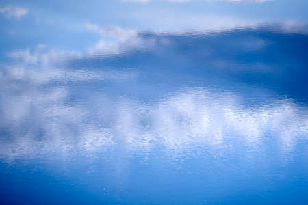 water background, the reflection of the sky in the rippling waterの写真素材
