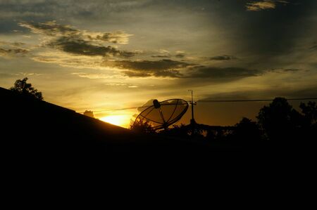 Satellite dish in twilight sky background.の素材