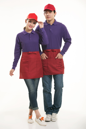 Asian waiter and waitress standing in white backgroundの写真素材