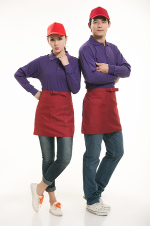 Asian waiter and waitress standing in white backgroundの写真素材