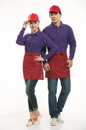 Asian waiter and waitress standing in white backgroundの写真素材