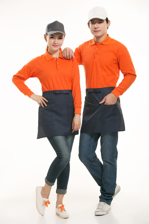 Asian waiter and waitress standing in white backgroundの写真素材