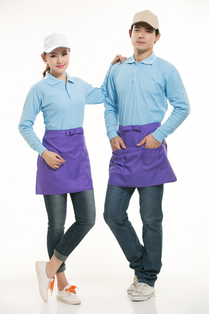 Asian waiter and waitress standing in white backgroundの写真素材