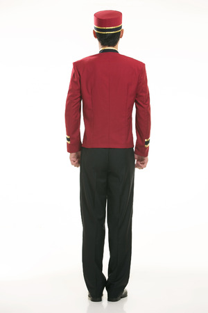Wearing red clothing waiter in front of a white backgroundの写真素材