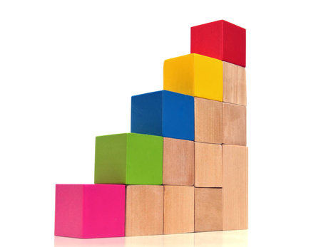 Stairs of multicolored toy bricks on white background