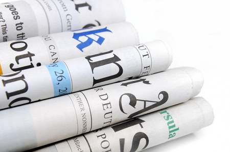 Various newspapers over white background のeditorial素材
