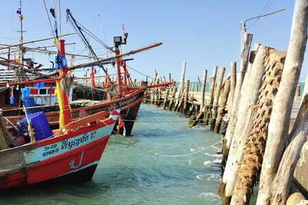 Several multicolored fishing boats in a small harbour in Thailand のeditorial素材