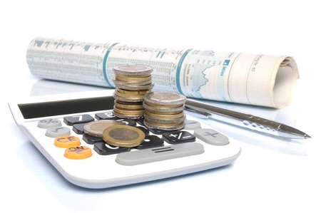 Calculator with Euro coins, ball pen and stock market report on white backgroundの写真素材