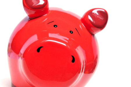 Smiling red piggy bank on whiteの写真素材