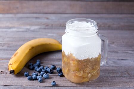 Yogurt with berries in a glass jarの写真素材