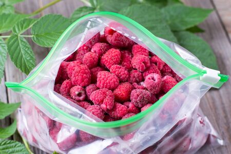 Frozen raspberry in plastic bagの写真素材