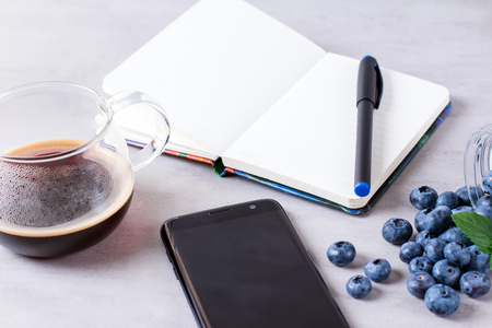 Coffee with notebook and telephoneの写真素材