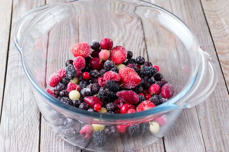 Frozen berries in a glass bowlの写真素材